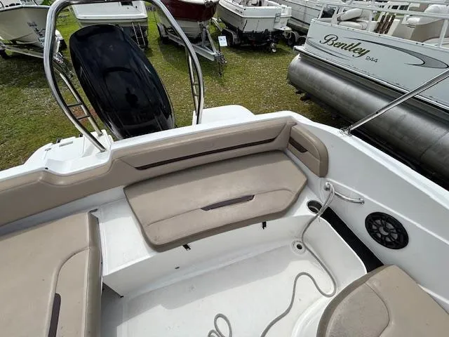 Slide: The Image of 2022 Hurricane SS 205 OB boat interior with beige seating and speaker system. - 9