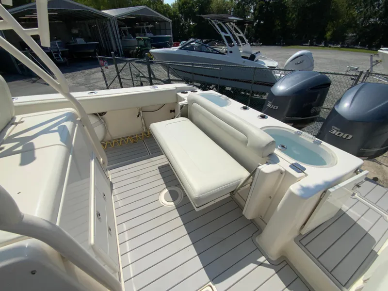 Slide: The Image of 2013 Cobia 296 Center Console boat interior with seating and twin Yamaha 300 engines. - 16