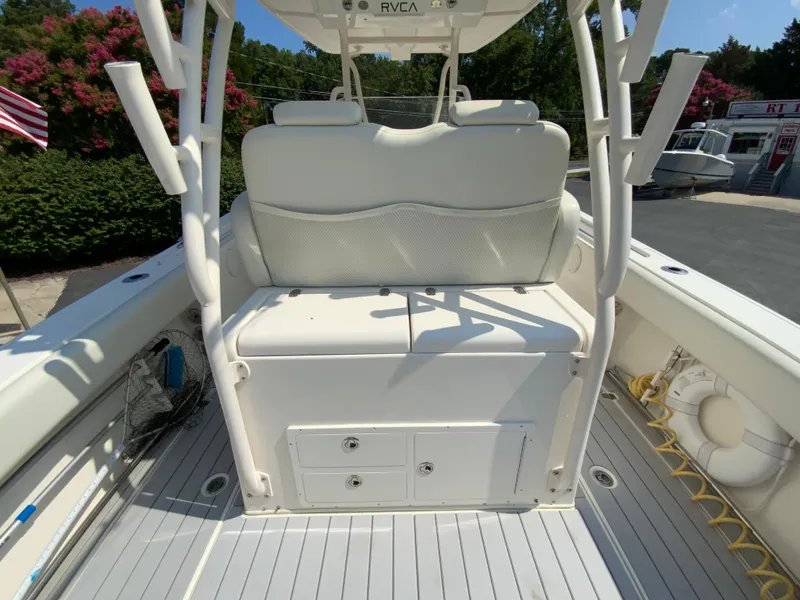 Slide: The Image of 2013 Cobia 296 Center Console boat interior with seating and storage compartments. - 18