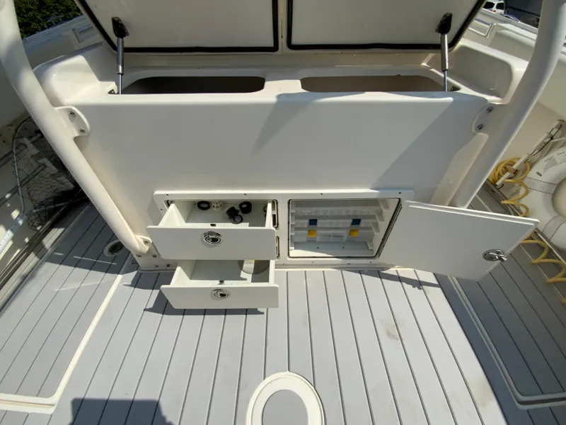 Slide: The Image of 2013 Cobia 296 Center Console boat storage compartments and deck view. - 20