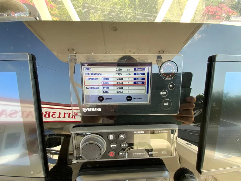 Slide: The Image of Yamaha display on 2013 Cobia 296 Center Console showing trip data and settings. - 21