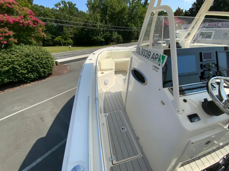Slide: The Image of 2013 Cobia 296 Center Console boat with sleek design and modern dashboard. - 22