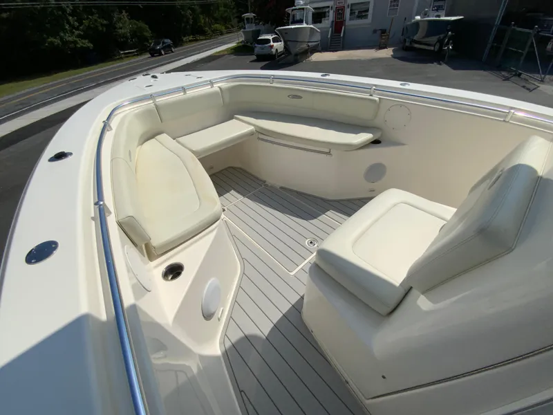 Slide: The Image of 2013 Cobia 296 Center Console boat interior with cushioned seating and sleek design. - 23