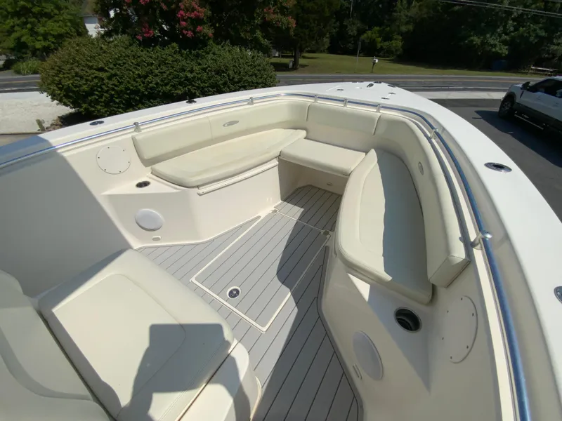 Slide: The Image of 2013 Cobia 296 Center Console boat with spacious seating and sleek design. - 24