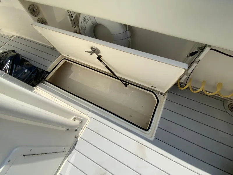 Slide: The Image of Open storage compartment on 2013 Cobia 296 Center Console boat deck. - 35