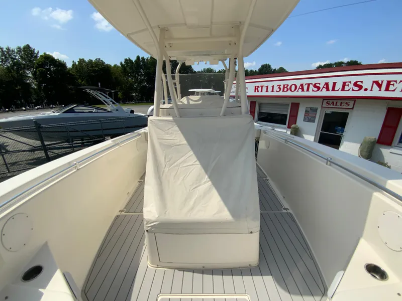 Slide: The Image of 2013 Cobia 296 Center Console boat at a sales dock, covered seating area visible. - 36