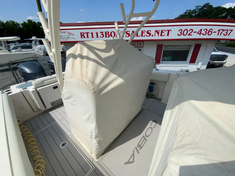 Slide: The Image of 2013 Cobia 296 Center Console boat at RT113 Boat Sales, covered and docked. - 37