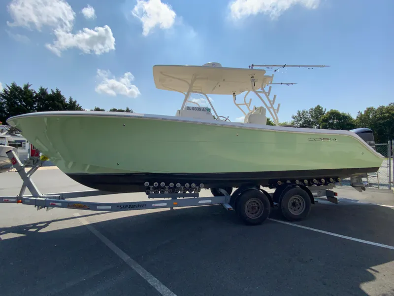 Slide: The Image of 2013 Cobia 296 Center Console boat on trailer under blue sky. - 6