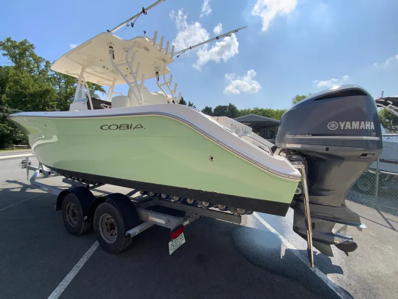 Slide: The Image of 2013 Cobia 296 Center Console boat on trailer with Yamaha outboard motor. - 7