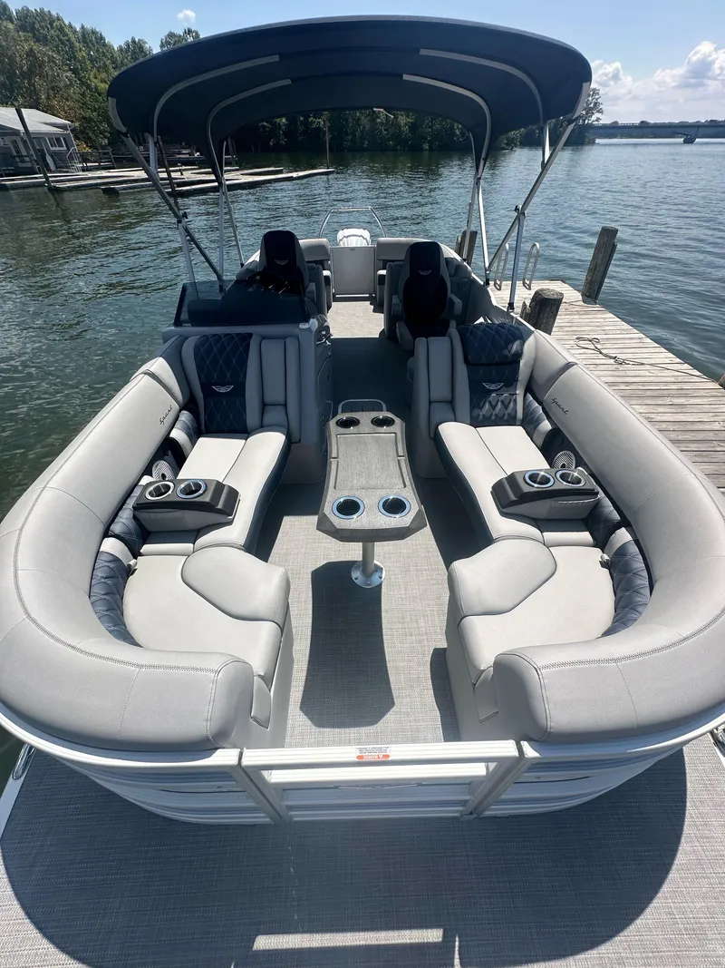 Slide: The Image of 2025 Bennington 23 RSR pontoon boat with luxurious seating and canopy on a serene lake. - 11
