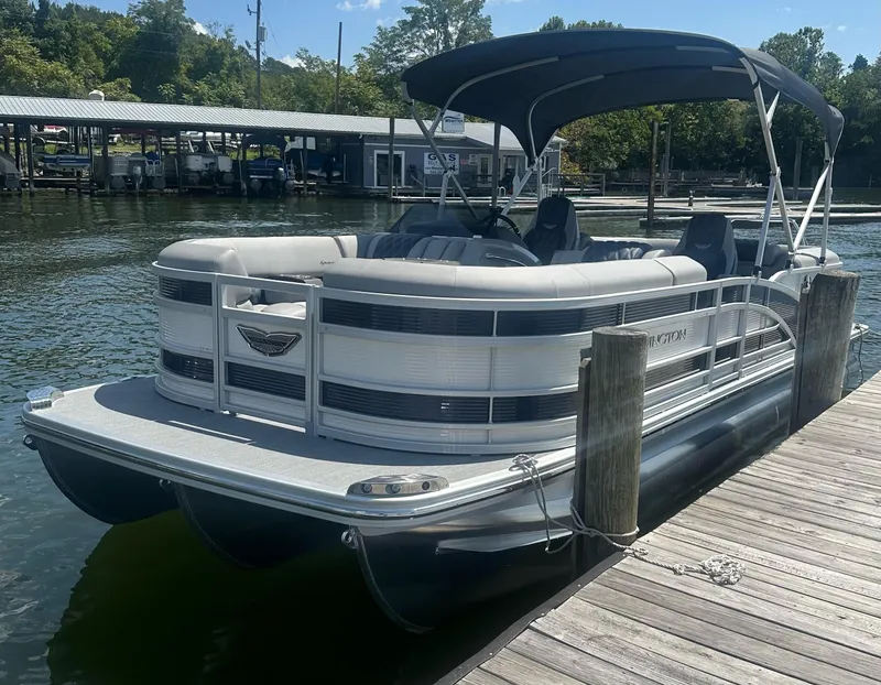 Slide: The Image of 2025 Bennington 23 RSR pontoon boat docked by a wooden pier. - 3