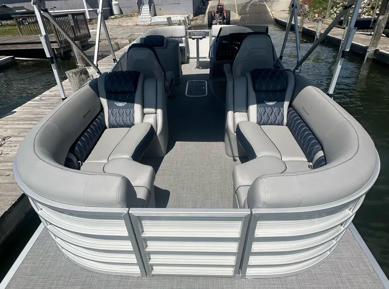 Slide: The Image of 2025 Bennington 23 RSR pontoon boat with luxurious seating and modern design at a dock. - 7