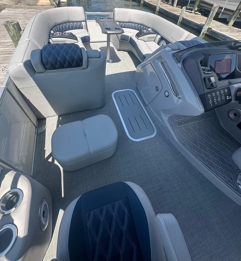 Slide: The Image of Luxurious interior of 2025 Bennington 23 RSR pontoon boat with plush seating and modern controls. - 9