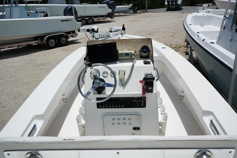 Slide: The Image of 2013 Renegade Nomad 22 boat cockpit with steering wheel and control panel. - 3
