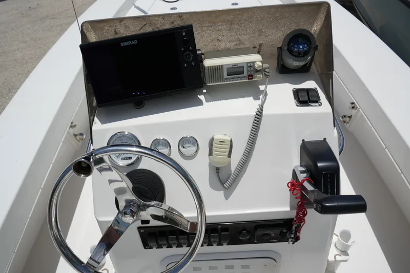 Slide: The Image of Control panel of 2013 Renegade Nomad 22 boat with steering wheel and navigation equipment. - 4