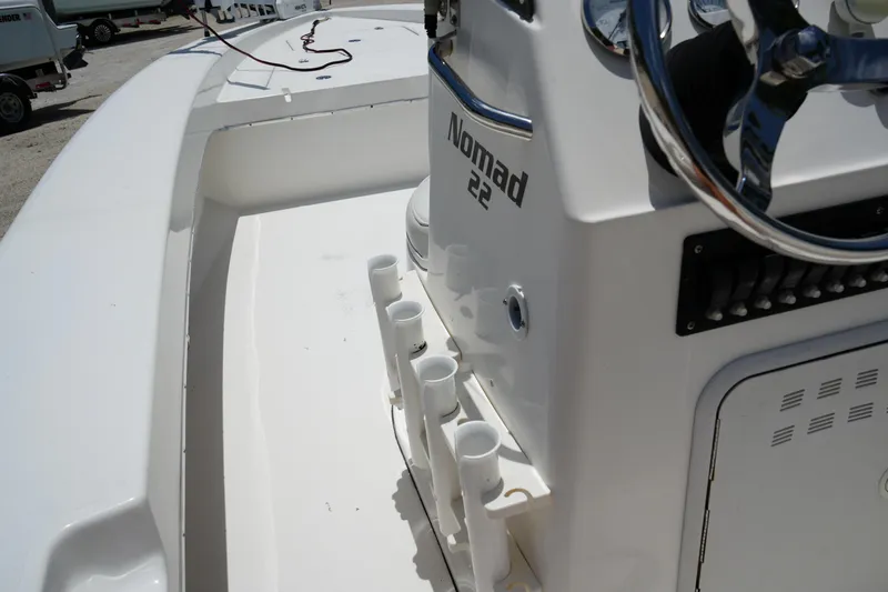 Slide: The Image of 2013 Renegade Nomad 22 boat console with steering wheel and rod holders. - 5