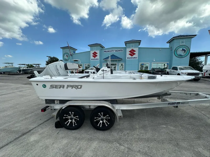 The Image of 2026 Sea Pro 172 Bay boat on display in a marina under clear blue sky. - 1