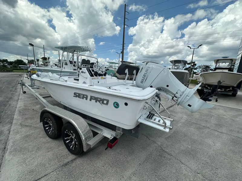 Slide: The Image of 2026 Sea Pro 172 Bay boat with Suzuki engine displayed at a marine dealership. - 3