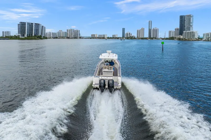 Slide: The Image of 2018 Boston Whaler 280 Outrage cruising in urban waterfront, city skyline in background. - 10