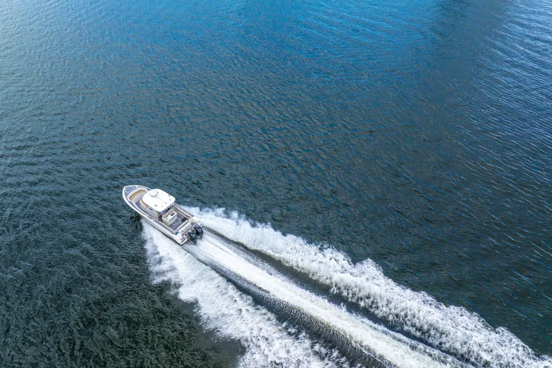 Slide: The Image of Aerial view of 2018 Boston Whaler 280 Outrage speeding on open water. - 12