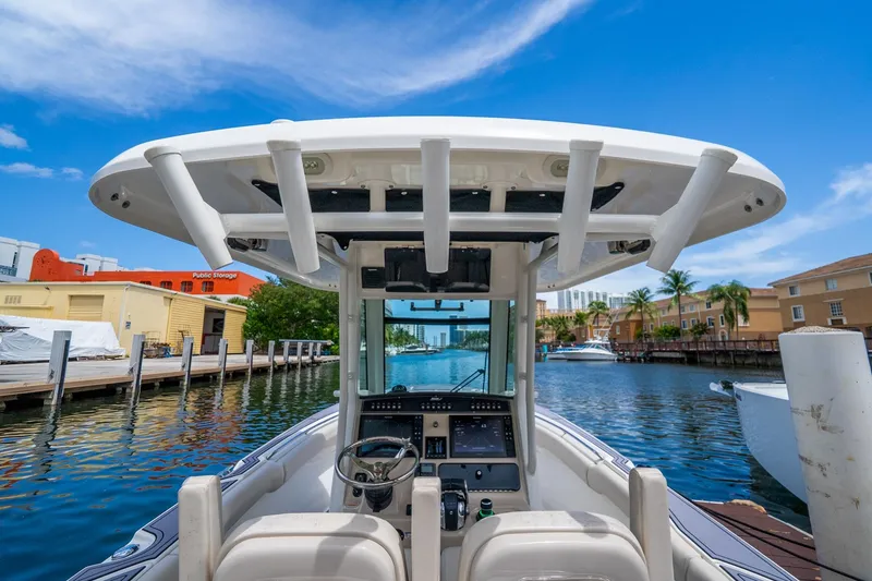 Slide: The Image of 2018 Boston Whaler 280 Outrage boat docked in a scenic marina setting. - 16