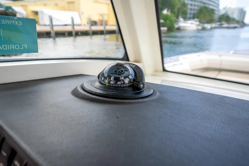 Slide: The Image of Compass on 2018 Boston Whaler 280 Outrage dashboard, with waterfront view. - 23