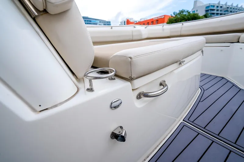 Slide: The Image of 2018 Boston Whaler 280 Outrage interior with cushioned seating and stainless steel fixtures. - 26