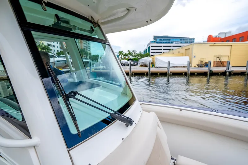 Slide: The Image of 2018 Boston Whaler 280 Outrage boat docked near waterfront buildings. - 28