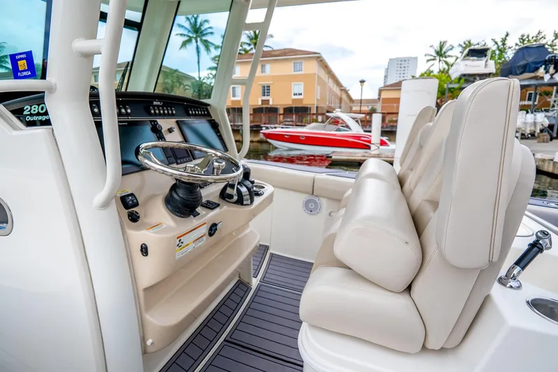 Slide: The Image of 2018 Boston Whaler 280 Outrage helm with luxurious seating and modern controls. - 32