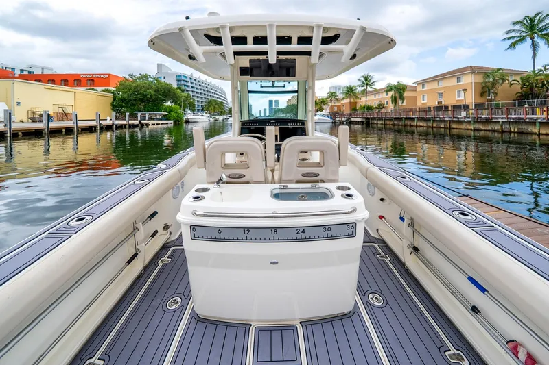 Slide: The Image of 2018 Boston Whaler 280 Outrage boat interior, docked in a scenic canal setting. - 33