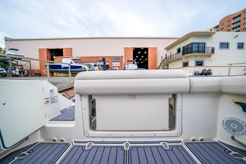 Slide: The Image of 2018 Boston Whaler 280 Outrage boat interior at marina with storage buildings. - 36