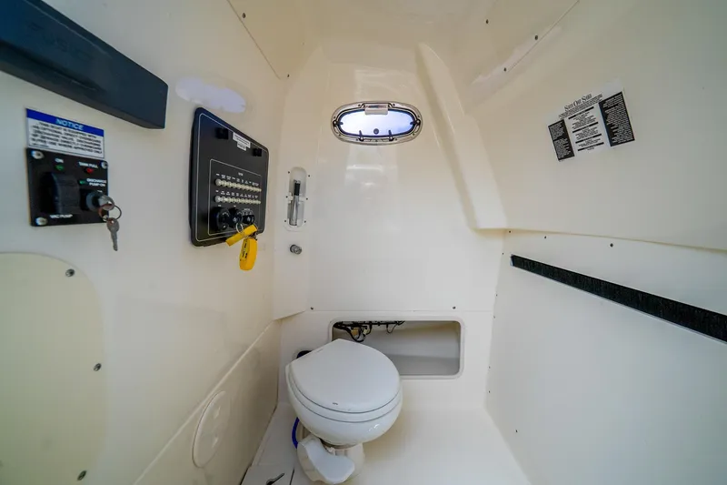 Slide: The Image of Interior of 2018 Boston Whaler 280 Outrage boat, featuring a compact marine toilet. - 39