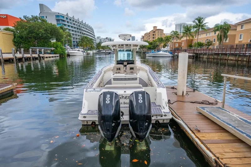 Slide: The Image of 2018 Boston Whaler 280 Outrage docked in a scenic marina with twin engines. - 41