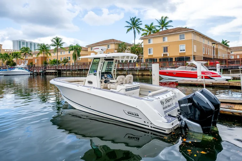 Slide: The Image of 2018 Boston Whaler 280 Outrage docked in a scenic marina with palm trees. - 42