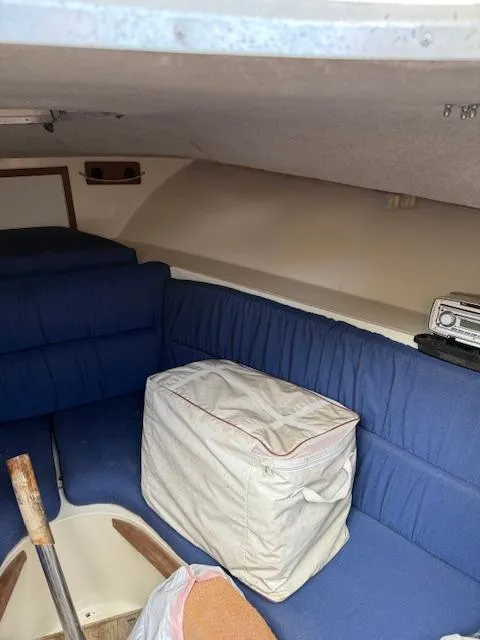 Slide: The Image of Interior of 1986 Blackfin 27 boat with blue seating and storage bag. - 11