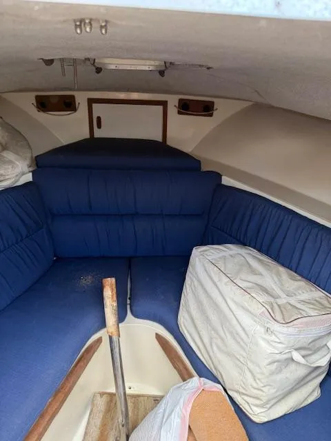 Slide: The Image of Interior of 1986 Blackfin 27 boat with blue seating and storage. - 12