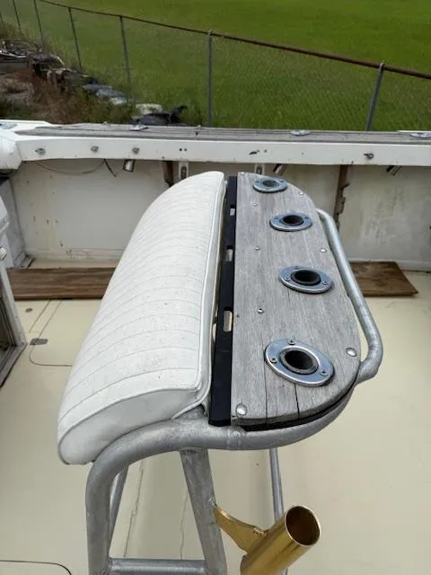 Slide: The Image of 1986 Blackfin 27 boat with rod holders and cushioned seating on deck. - 22