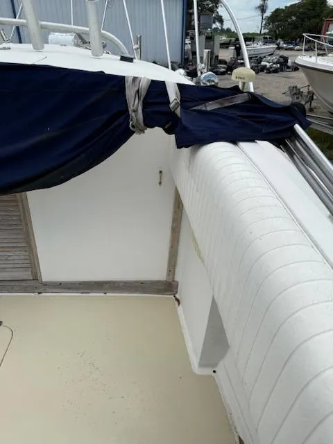 Slide: The Image of 1986 Blackfin 27 boat interior with blue cover and white seating. - 27