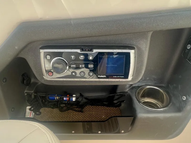 Slide: The Image of Fusion stereo system on 2015 Grady-White 275 Freedom boat dashboard with cup holder. - 11