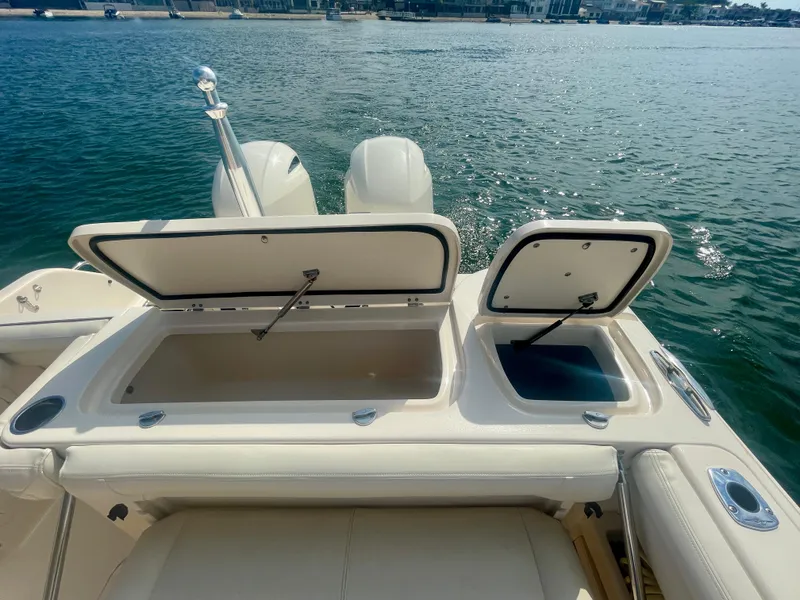 Slide: The Image of 2015 Grady-White 275 Freedom boat with open storage compartments on a sunny day. - 15