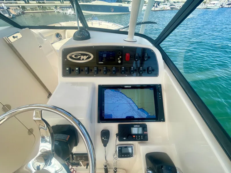 Slide: The Image of Control panel of 2015 Grady-White 275 Freedom boat with navigation system and steering wheel. - 19