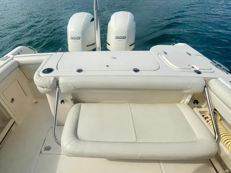 Slide: The Image of 2015 Grady-White 275 Freedom boat with dual 200 horsepower engines on open water. - 7