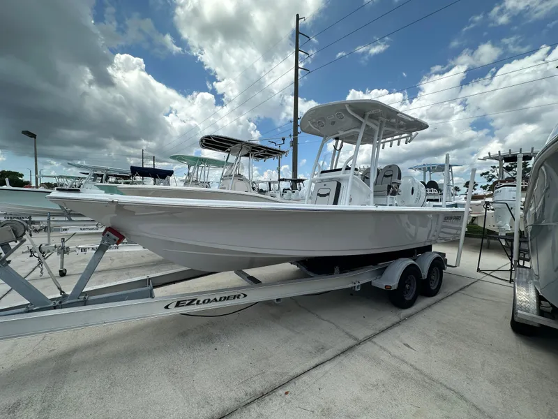 The Image of 2026 Sea Pro 230 Bay boat on trailer under cloudy sky. - 1