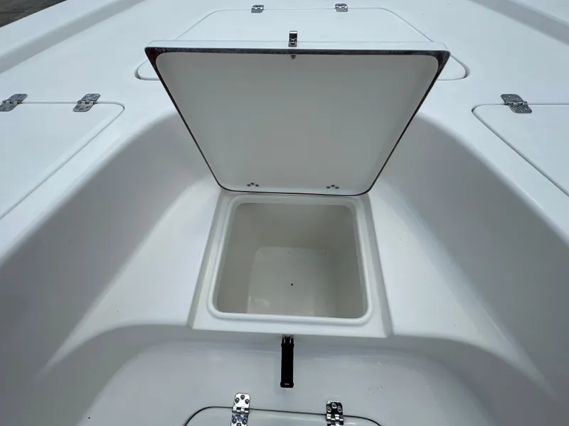 Slide: The Image of Open storage compartment on 2026 Sea Pro 230 Bay boat deck. - 10
