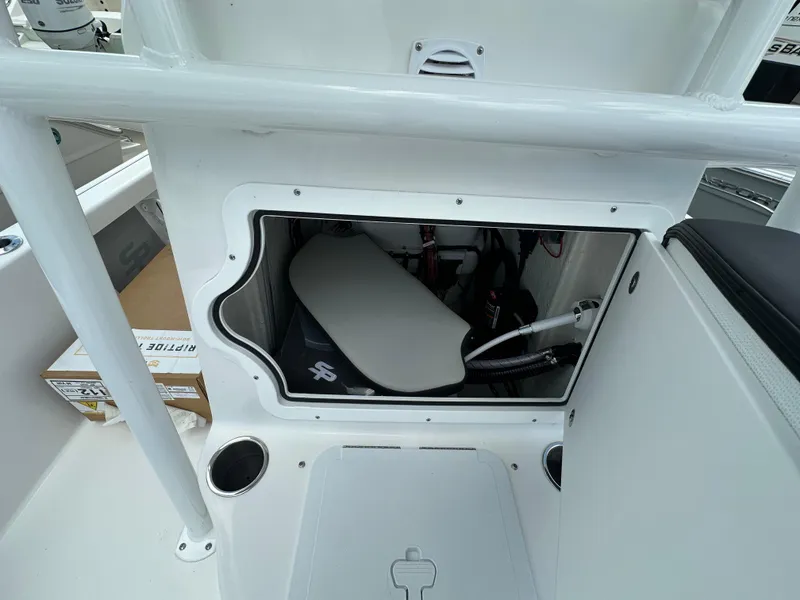 Slide: The Image of 2026 Sea Pro 230 Bay boat storage compartment with open hatch, showcasing interior details. - 13