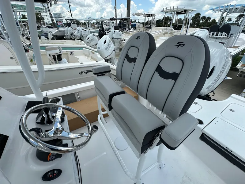 Slide: The Image of 2026 Sea Pro 230 Bay boat interior with dual seats and steering wheel. - 14