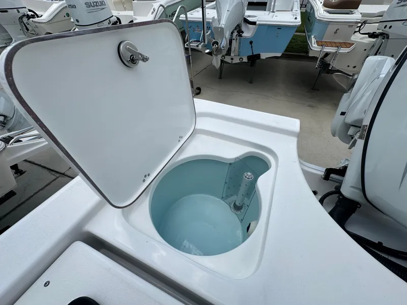 Slide: The Image of Livewell compartment on a 2026 Sea Pro 230 Bay boat, showcasing open lid and interior. - 17