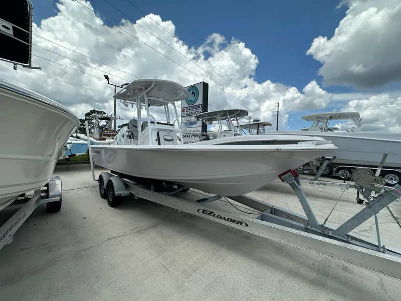 Slide: The Image of 2026 Sea Pro 230 Bay boat on trailer under cloudy sky. - 2