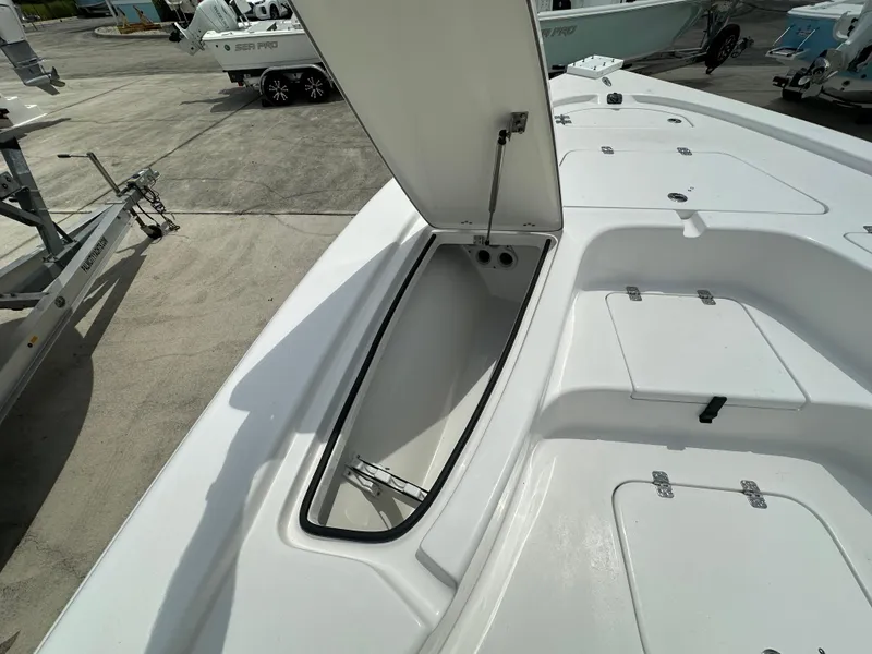 Slide: The Image of 2026 Sea Pro 230 Bay boat with open storage compartment on deck. - 7