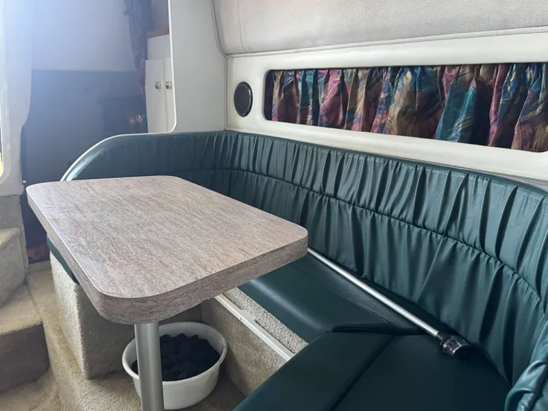 Slide: The Image of Interior of 1996 Rinker 280 Fiesta Vee boat with seating and table. - 10